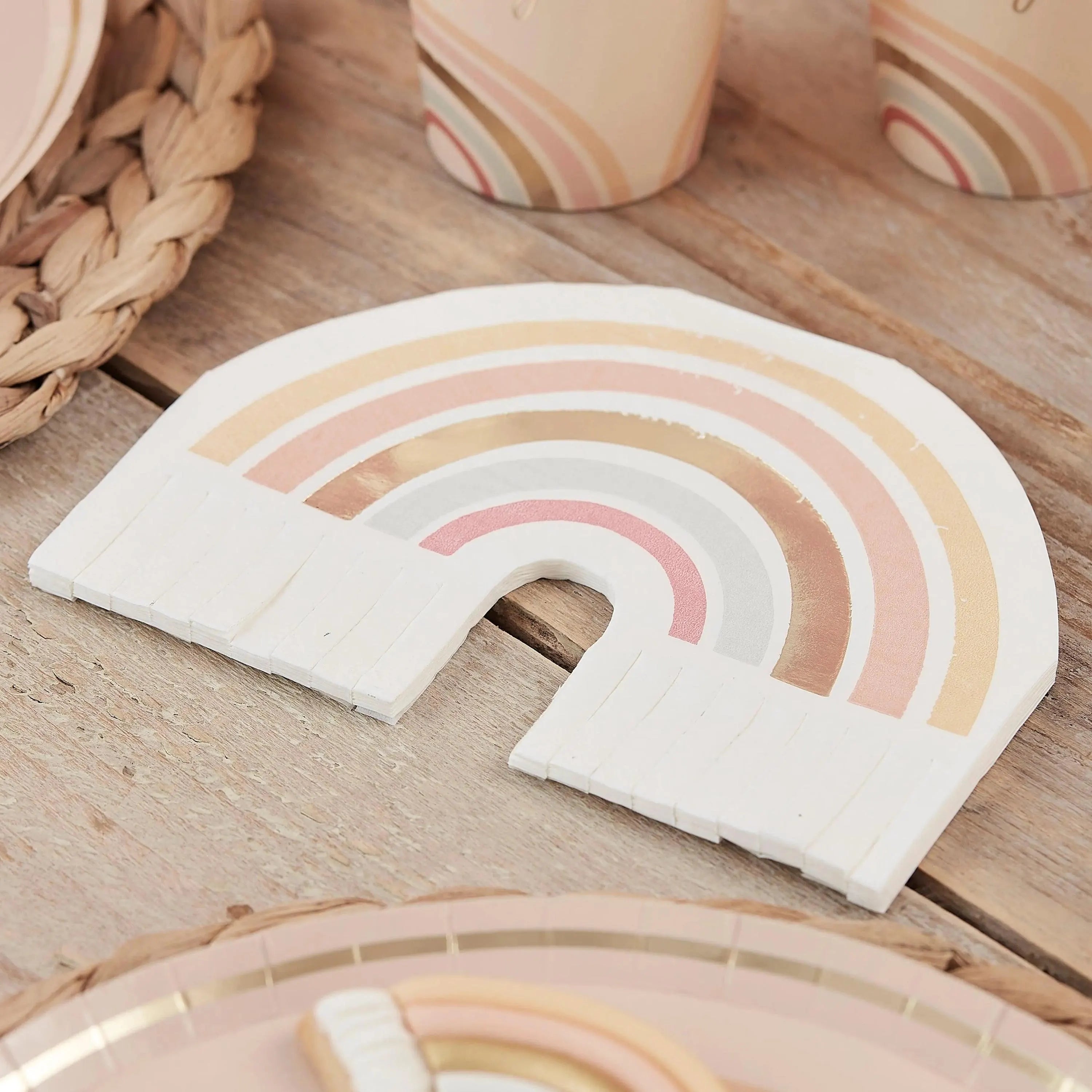 Boho gold foiled rainbow napkins on wooden table setting.